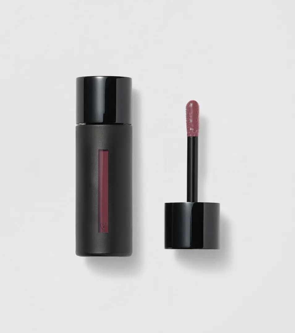 Westman Atelier Squeaky Clean Liquid Lip Balm in Garçonne, black tube with a mauve window beside its doe-foot applicator
