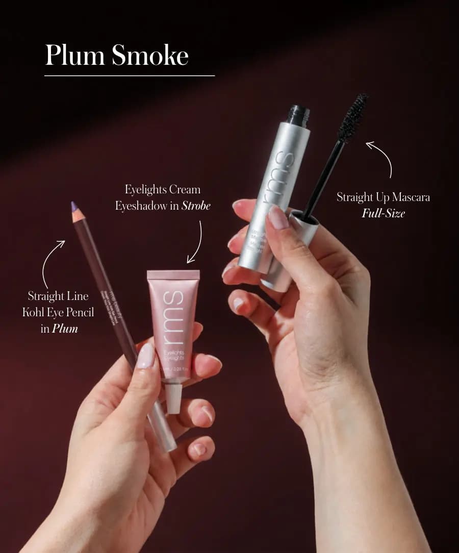 Hands hold the Plum Smoke trio, labelled Plum kohl pencil, Strobe Eyelights shadow and full-size mascara