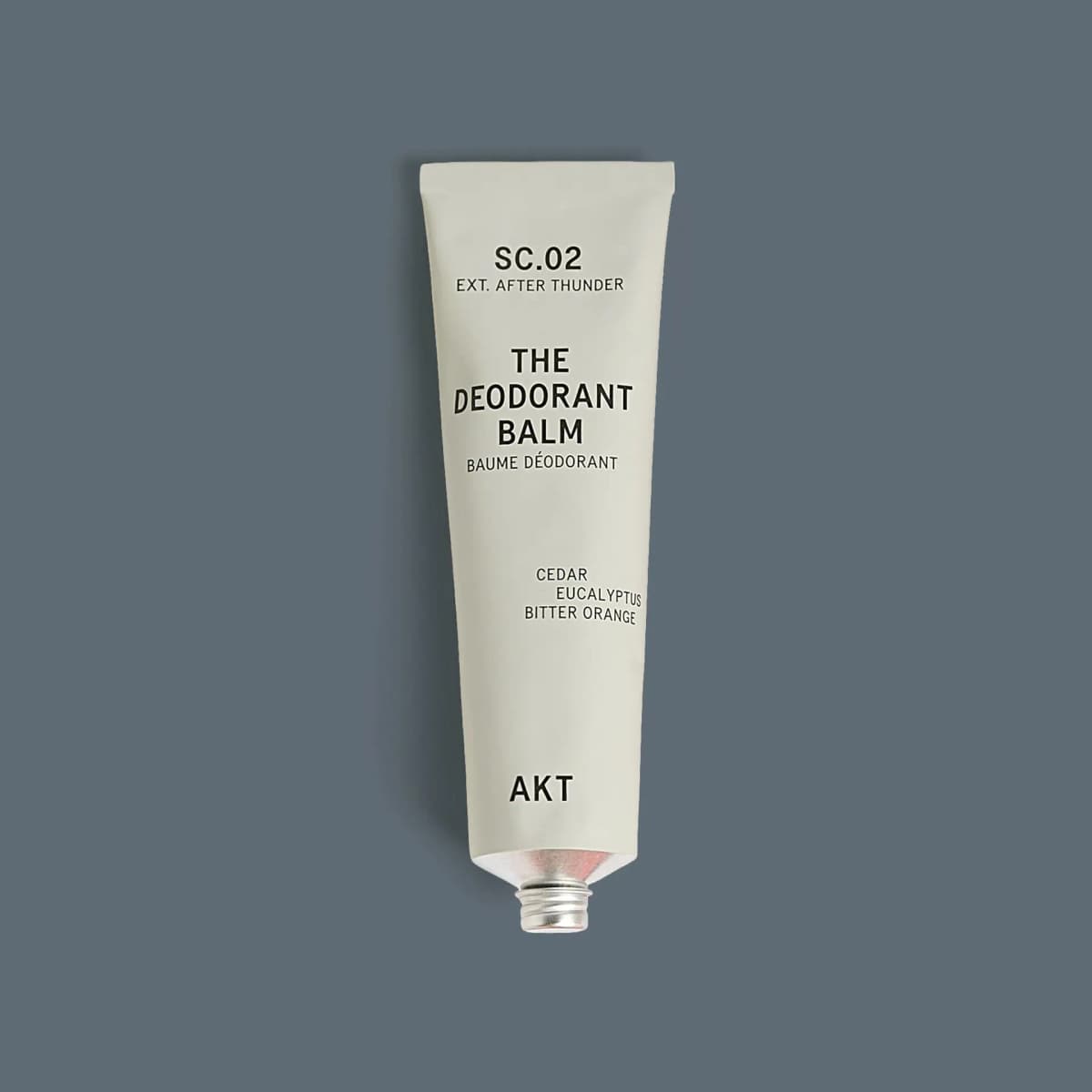 Pale grey AKT The Deodorant Balm SC.02 metal tube with cedar, eucalyptus and bitter orange notes on slate grey