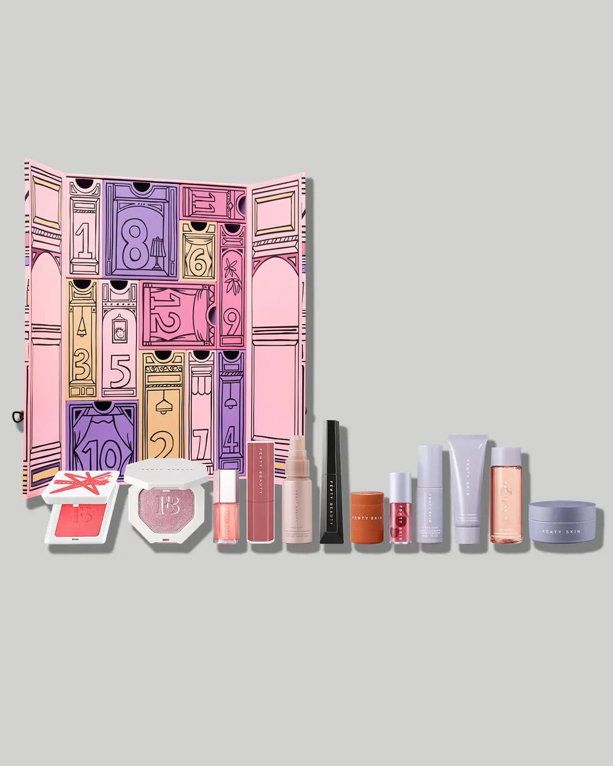 Opened Fenty advent calendar showing numbered doors with 12 makeup and skincare products lined up in front
