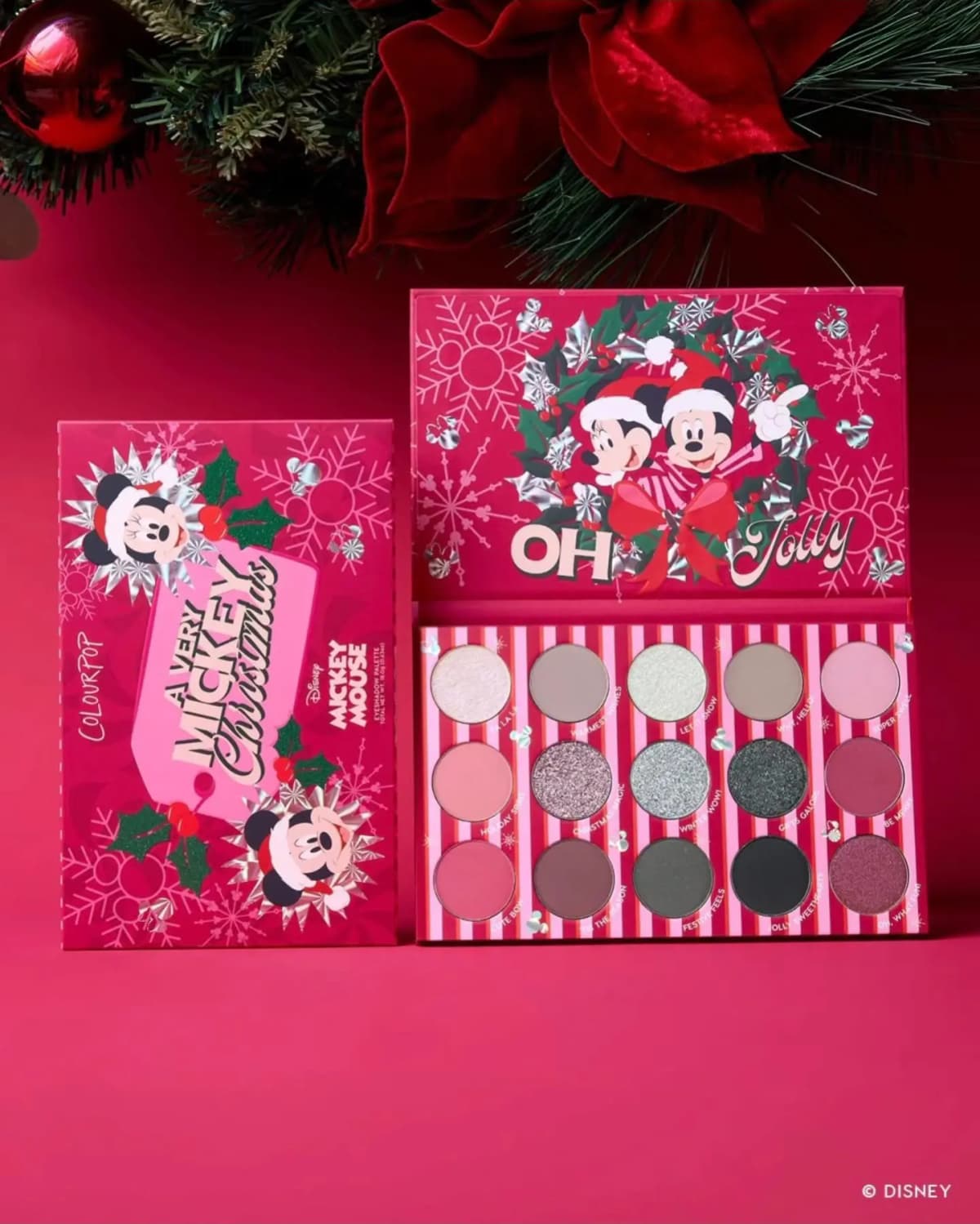 Open 15-pan Oh Jolly eyeshadow palette of pinks, berries, silvers and greys beside its A Very Mickey Christmas box