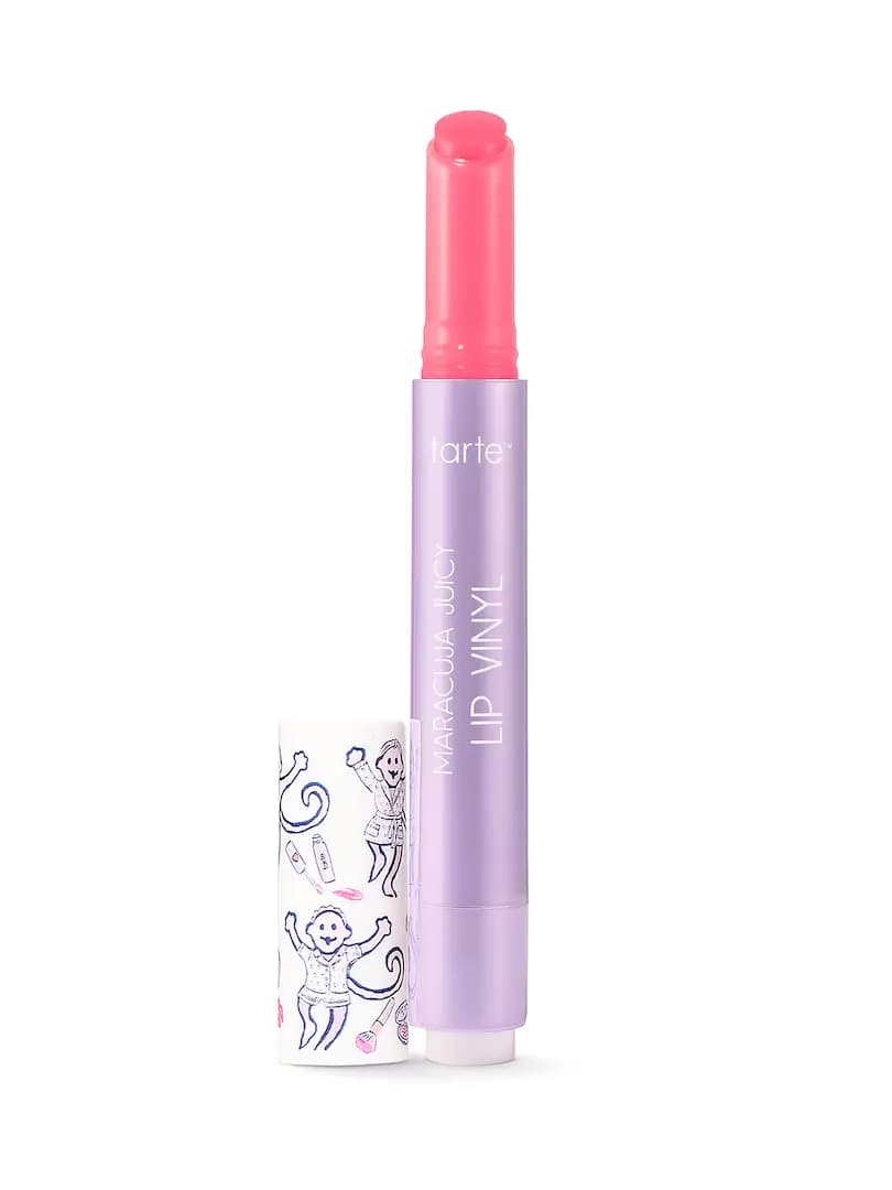Tarte Maracuja Juicy Lip Vinyl uncapped, showing pink balm, with white monkey-print cap beside it