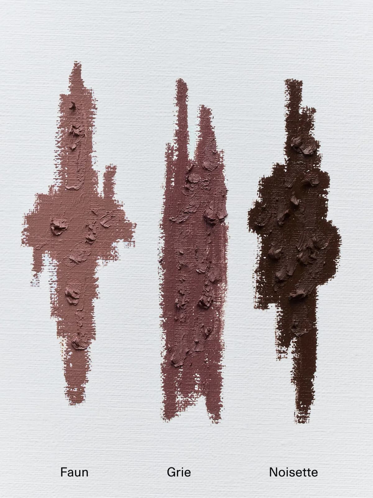 Thick textured swatches of Faun, Grie and Noisette on white canvas, from rosy nude to mauve to deep brown