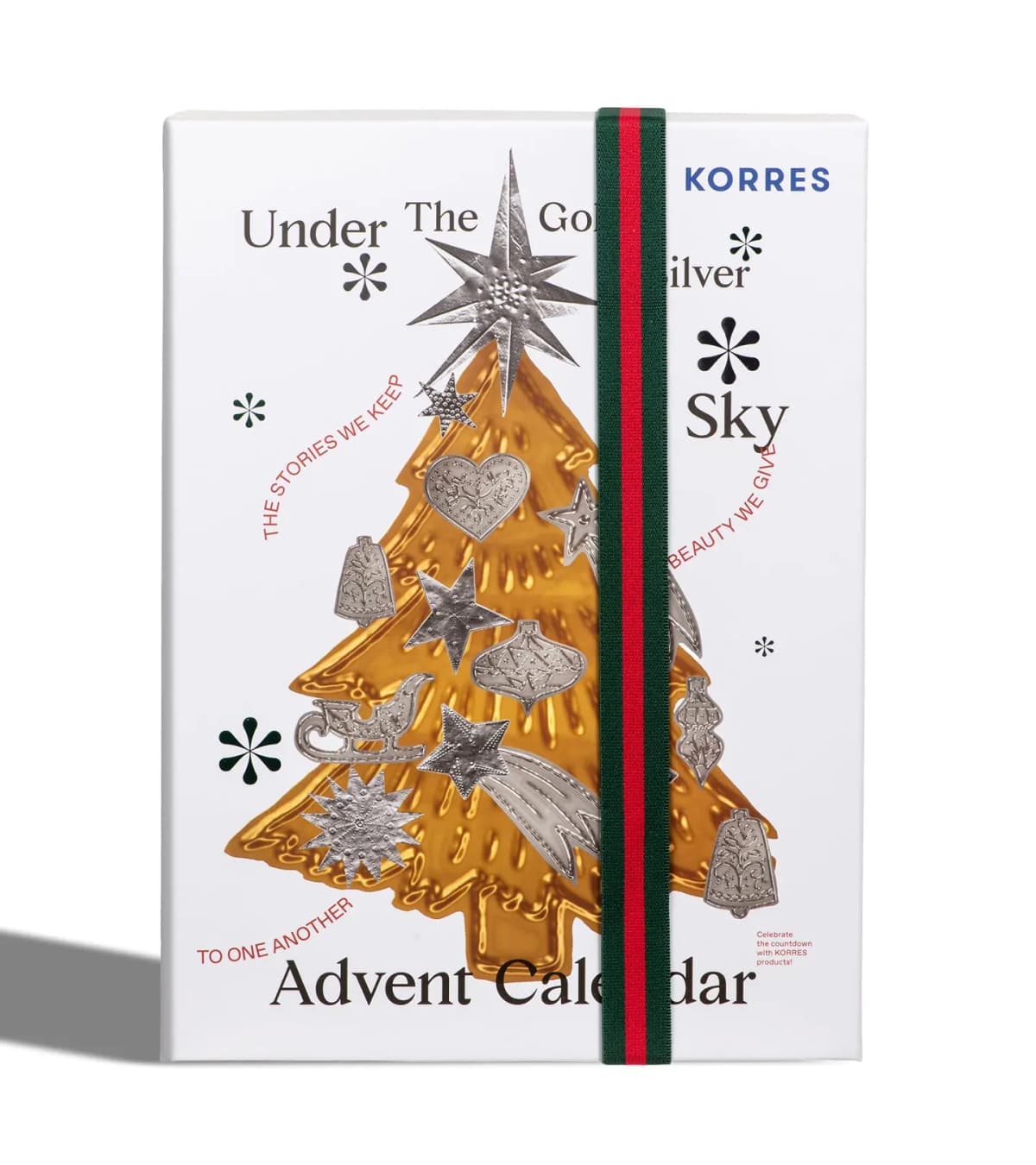 Closed KORRES Under The Gold & Silver Sky Advent Calendar with gold tree, silver ornaments and green-red band