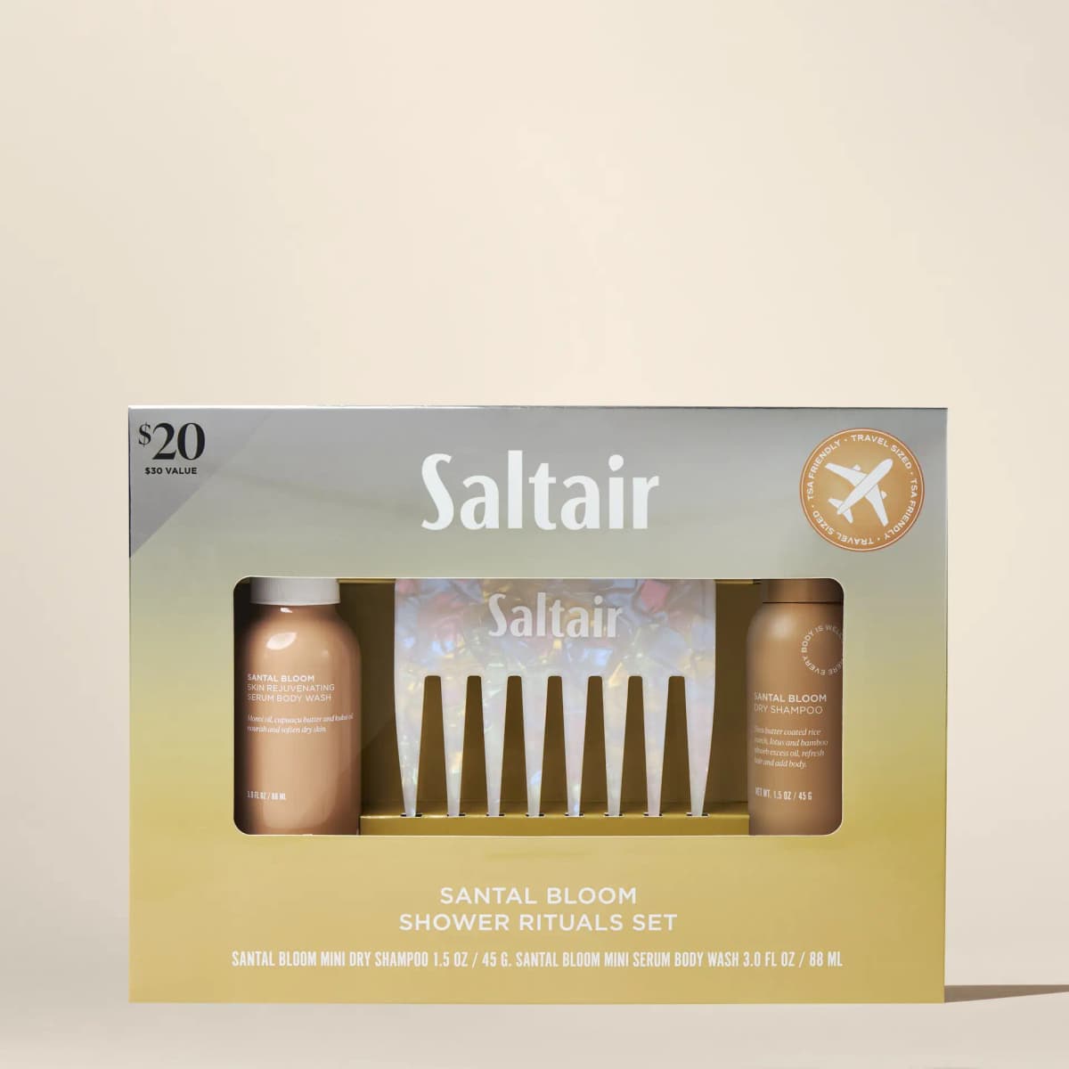 Gold-to-silver gift box with window showing mini body wash, iridescent comb and dry shampoo, priced $20