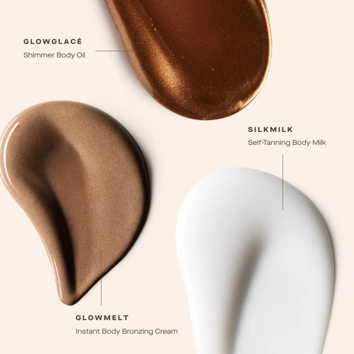 Swatches of shimmery bronze GlowGlacé oil, glossy tan GlowMelt cream and white SilkMilk body milk on cream.