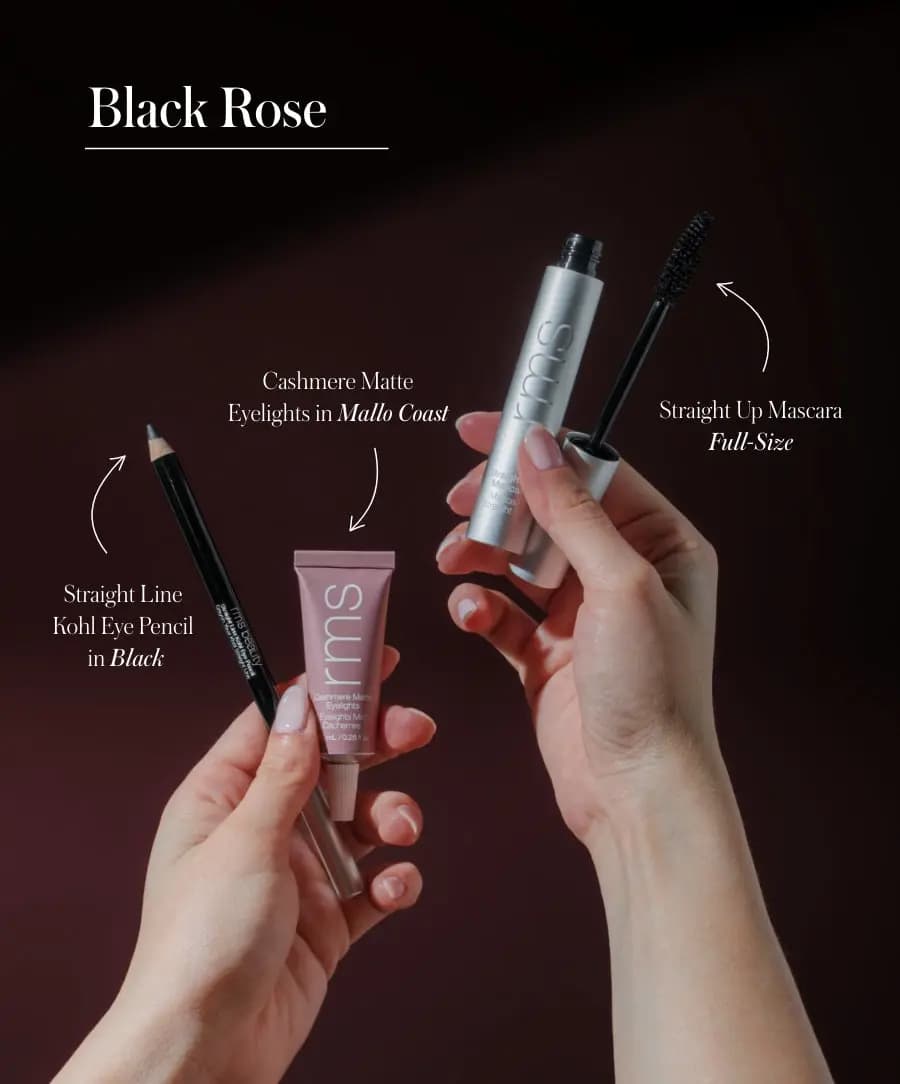 Hands hold the Black Rose trio, labelled Black kohl pencil, Mallo Coast Cashmere Matte Eyelights and mascara