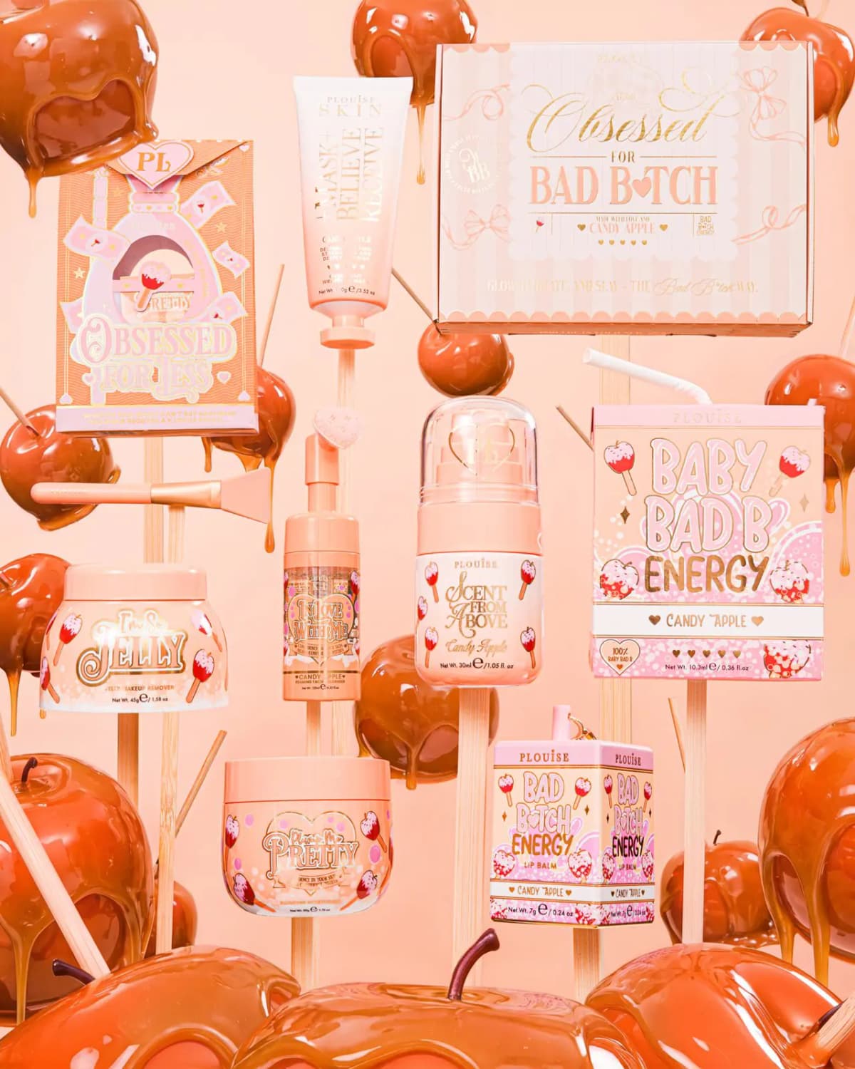 Candy Apple P.Louise skincare and gift boxes in peach and pink packaging among dripping caramel apples