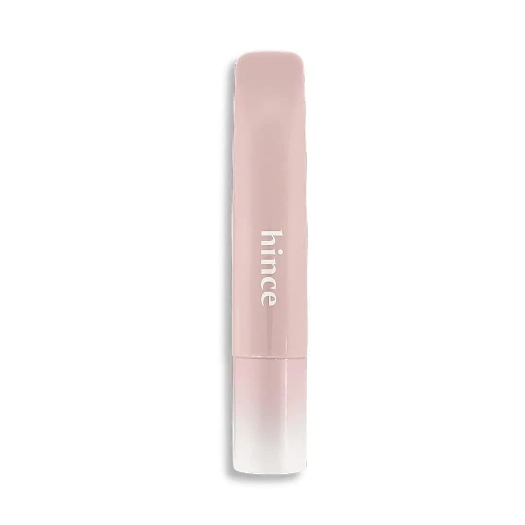 Dusty pale pink hince tube with white logo and soft blush gradient cap