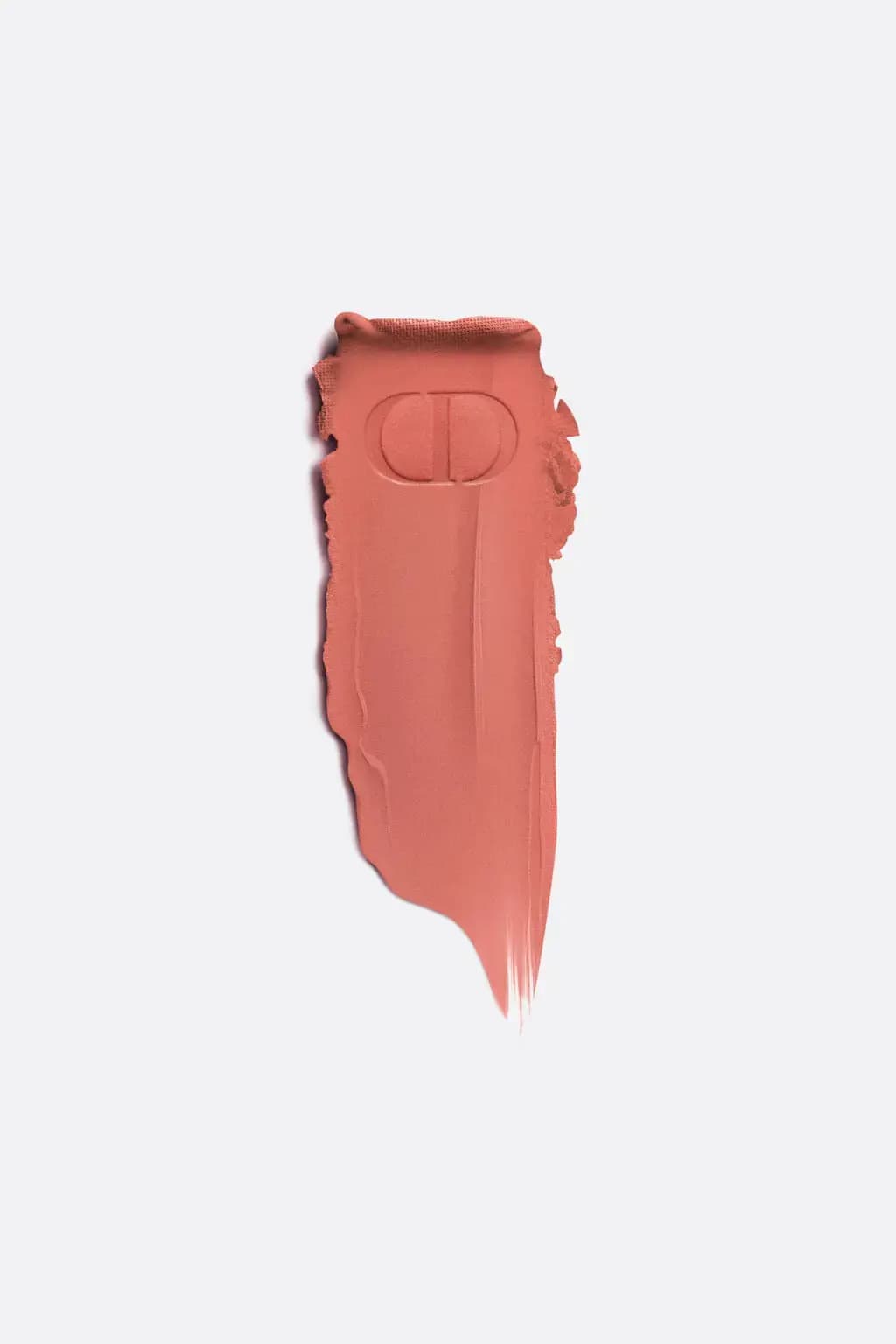 Smooth matte coral-peach lipstick swatch stamped with an embossed CD logo