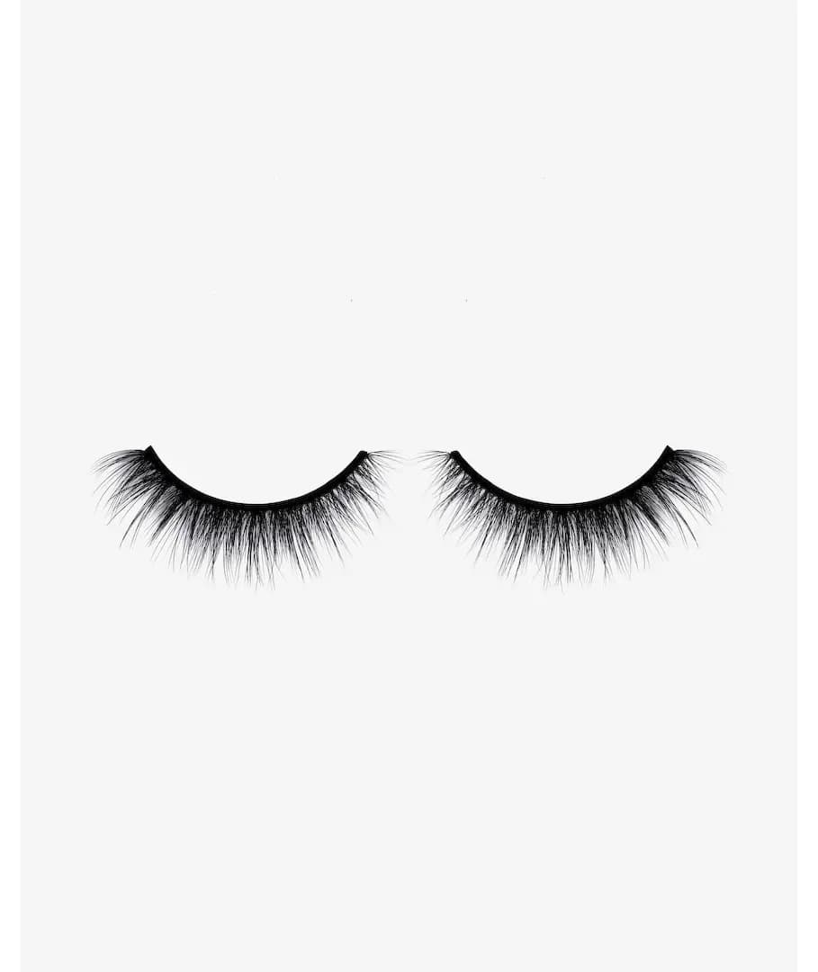 One pair of wispy black Blushing faux mink strip lashes with a thin black band on a pale grey background