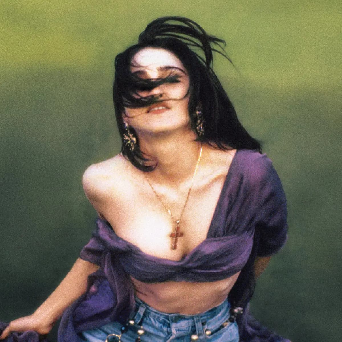 Herb Ritts' 1989 portrait of Madonna in a purple wrap top, cross necklace and denim against a green backdrop, used on the Like a Prayer vessel