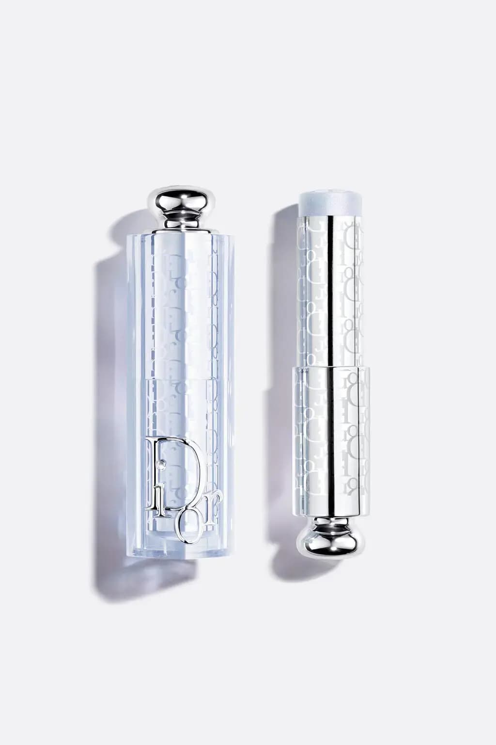 Clear Dior lipstick case with an oblique logo print next to an icy silver-blue shimmer bullet