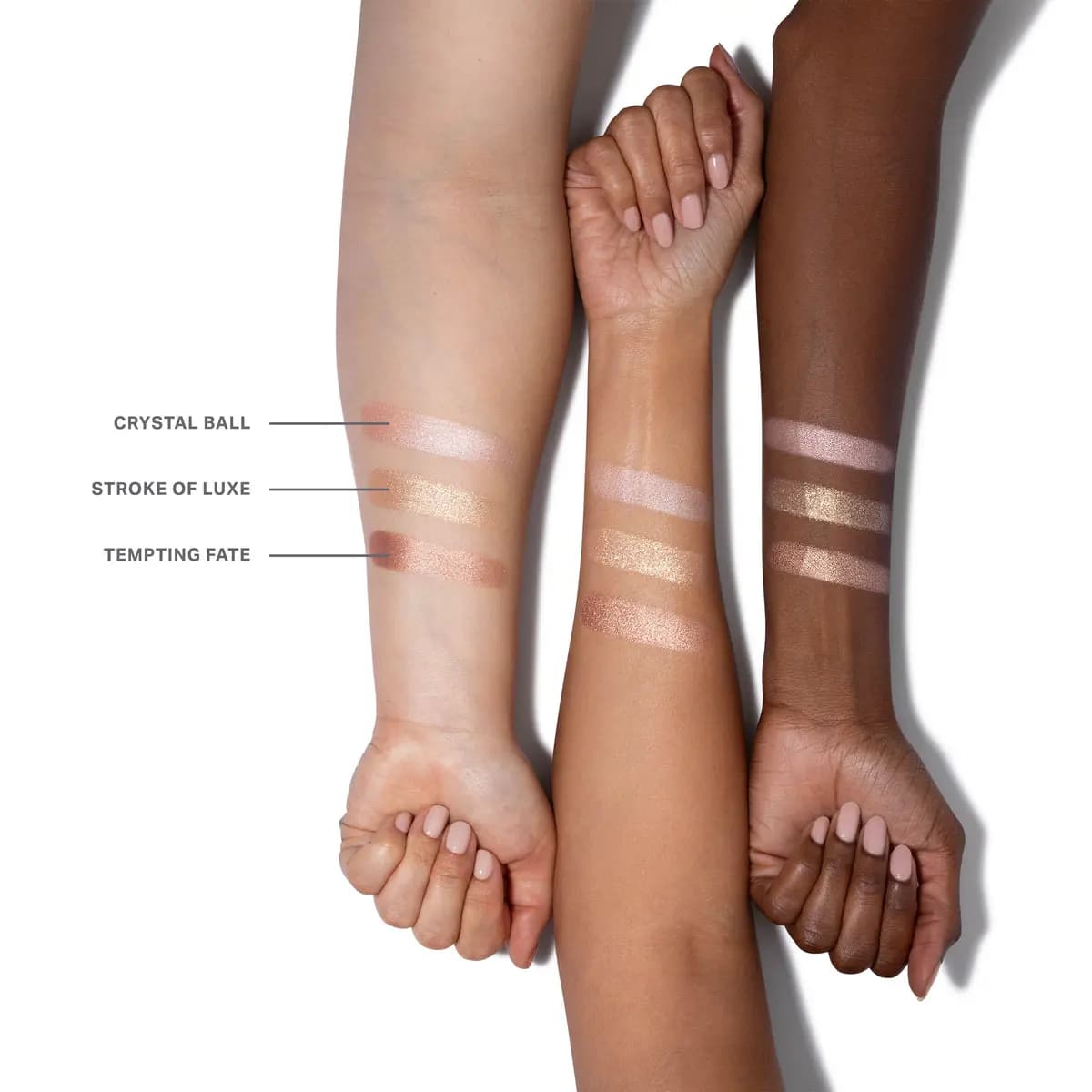 Crystal Ball, Stroke of Luxe and Tempting Fate shimmer swatches in pink, gold and rose on three arms
