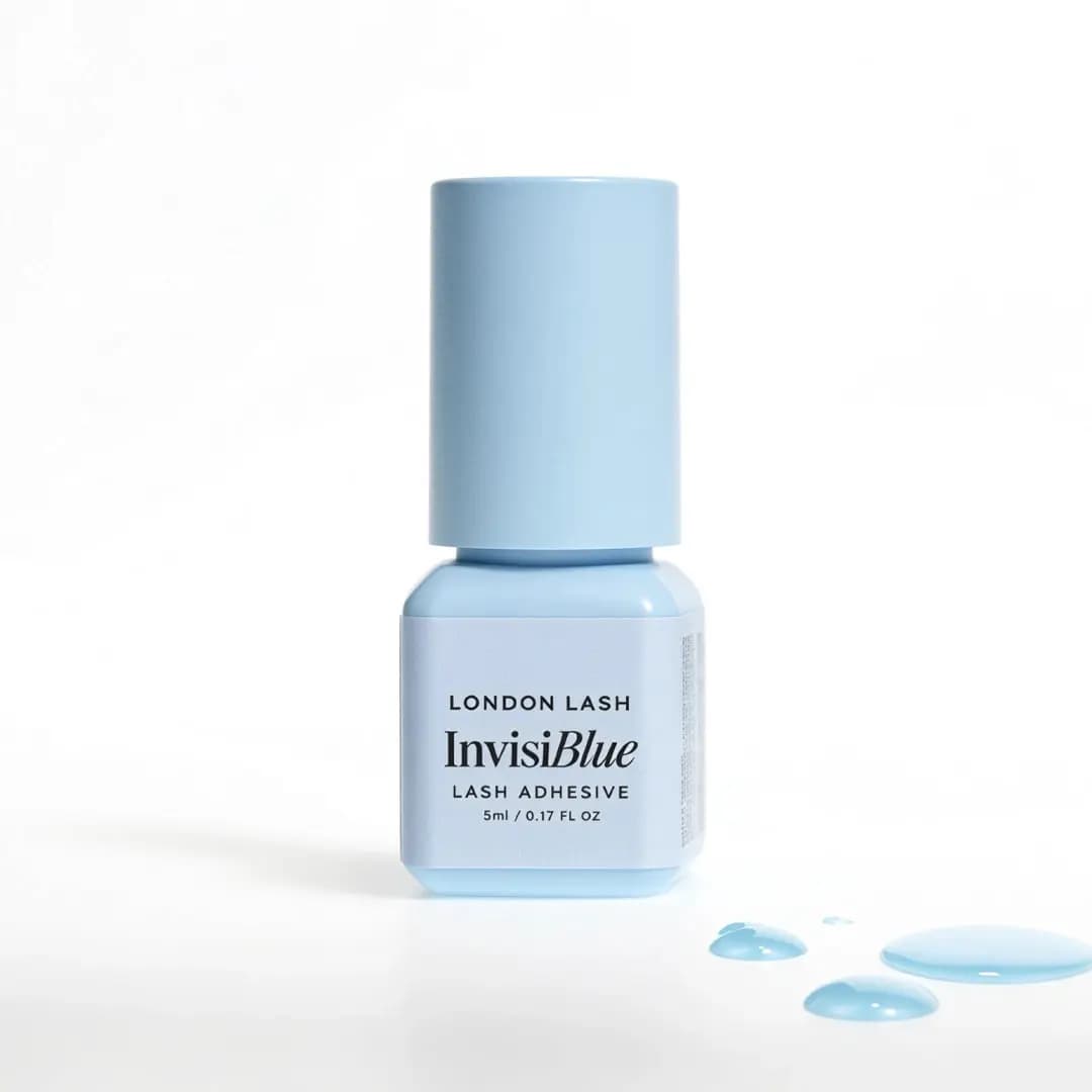 Light blue London Lash InvisiBlue Lash Adhesive 5ml bottle with droplets beside it on white background