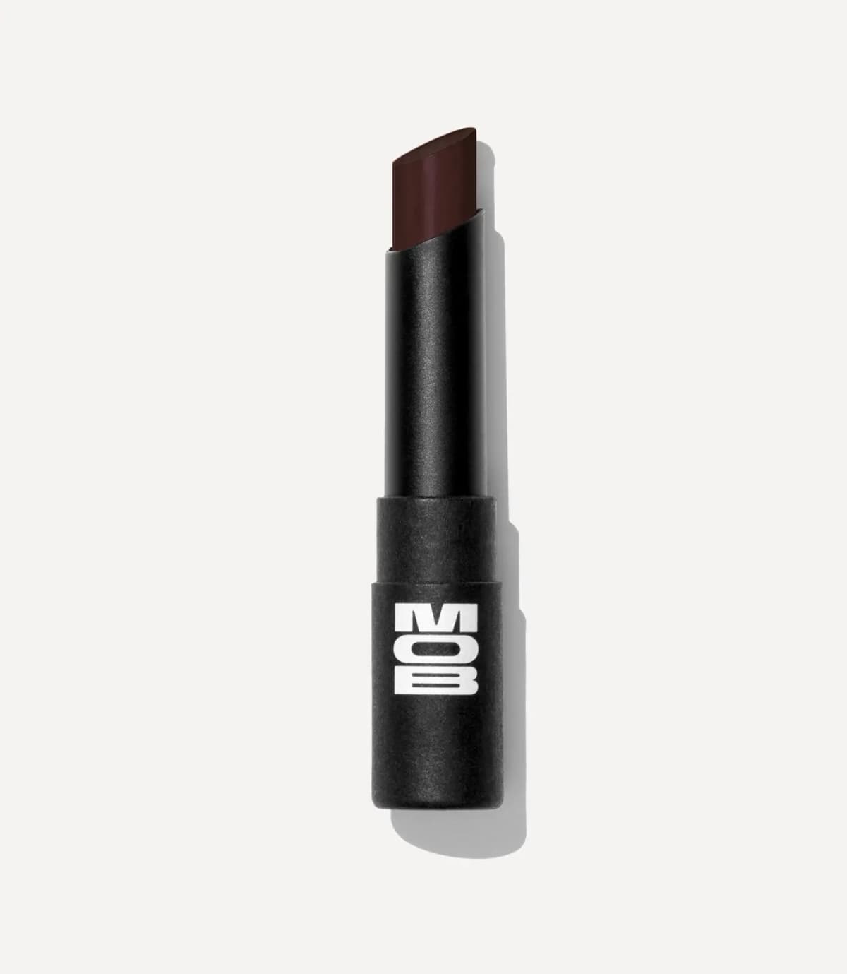 Black MOB lipstick-style balm uncapped to show a deep, almost black burgundy bullet