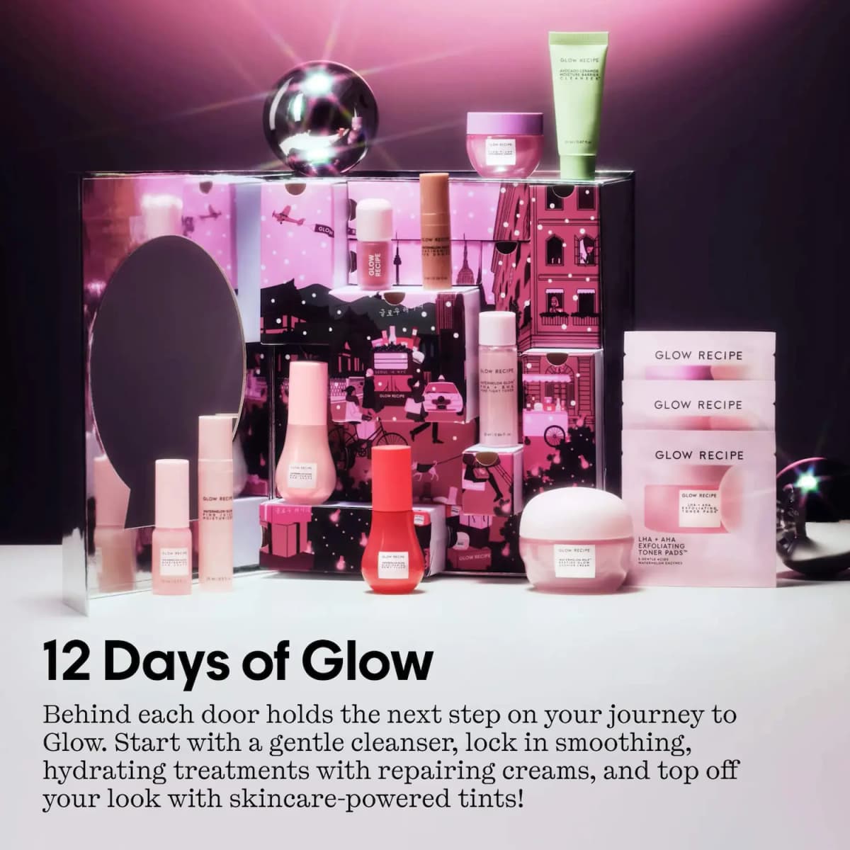 Opened 12 Days of Glow calendar with mirror and pink Seoul-NYC illustrated doors, products arranged around it