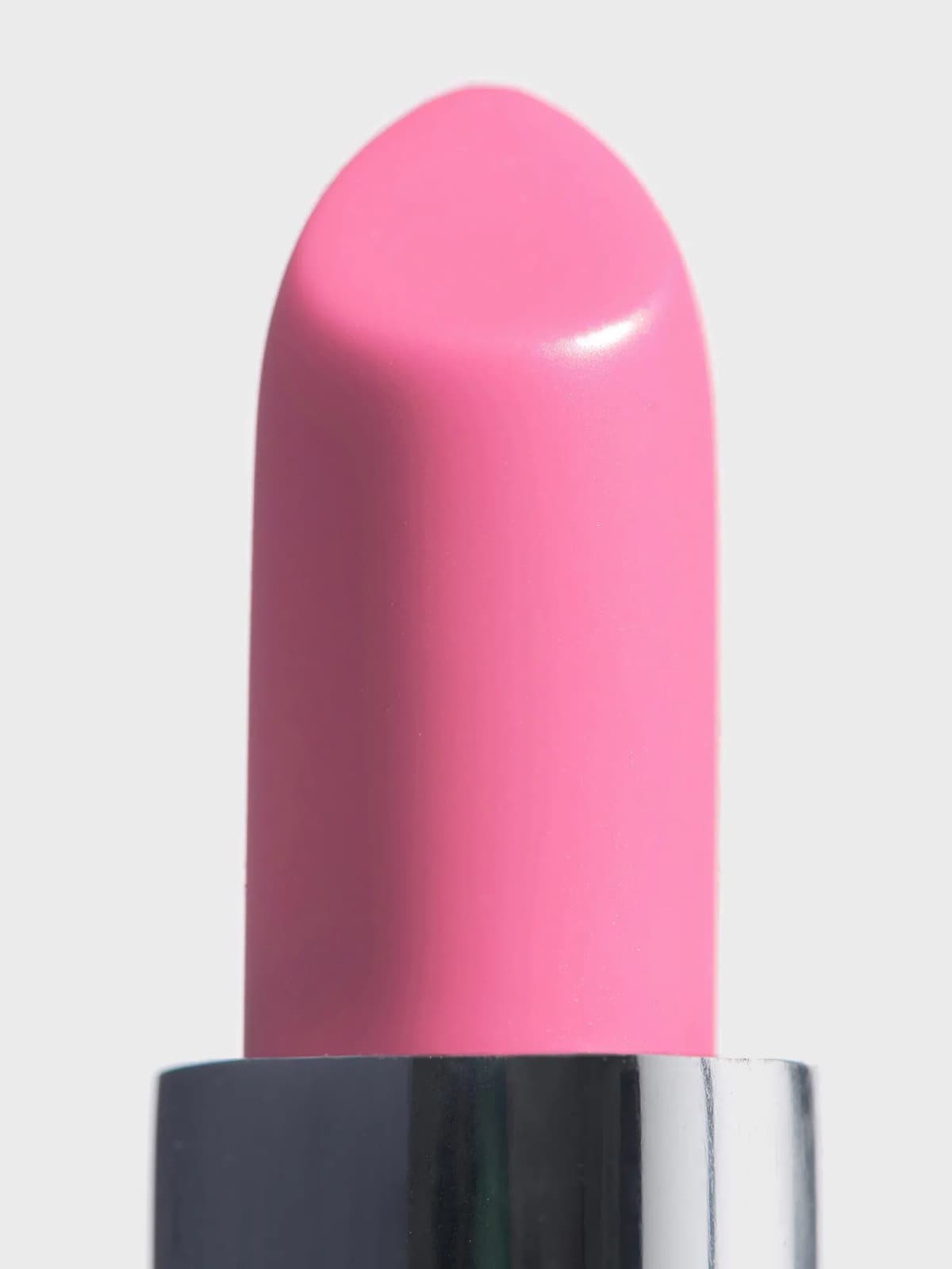 Close-up of the candy-pink Rose Bonbon balm bullet with a satin sheen, rising from a silver sleeve