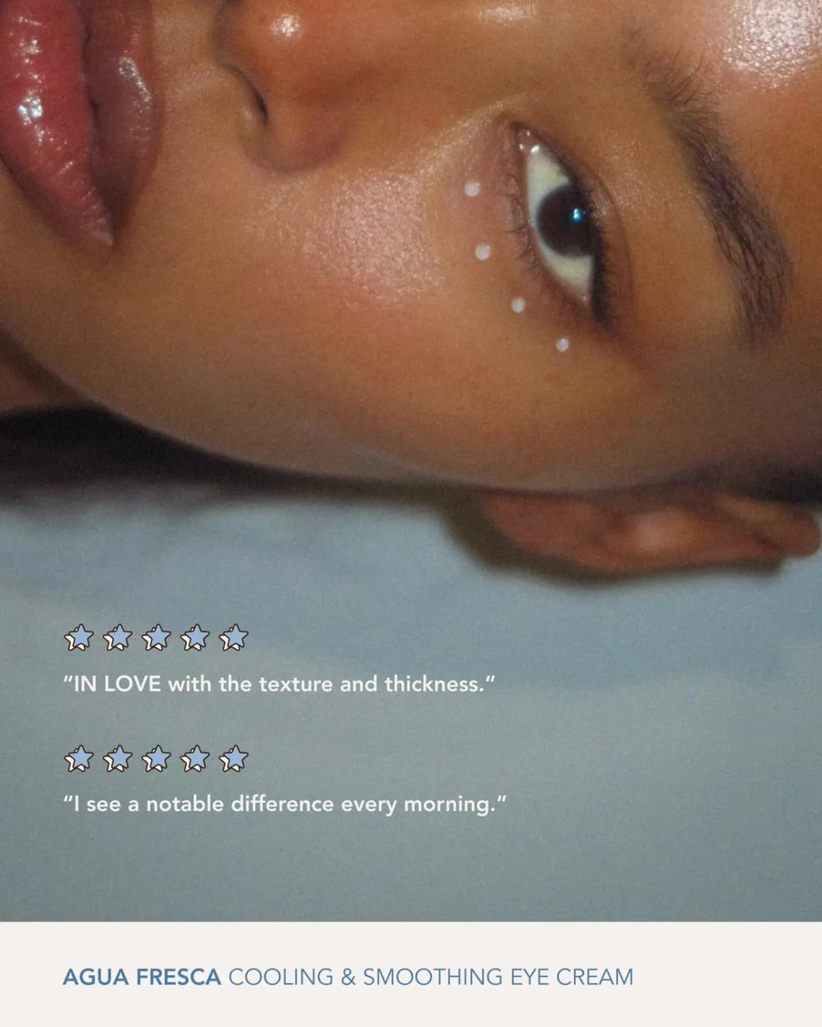 Close-up of a model lying down with dots of eye cream under the eye, with two five-star review quotes