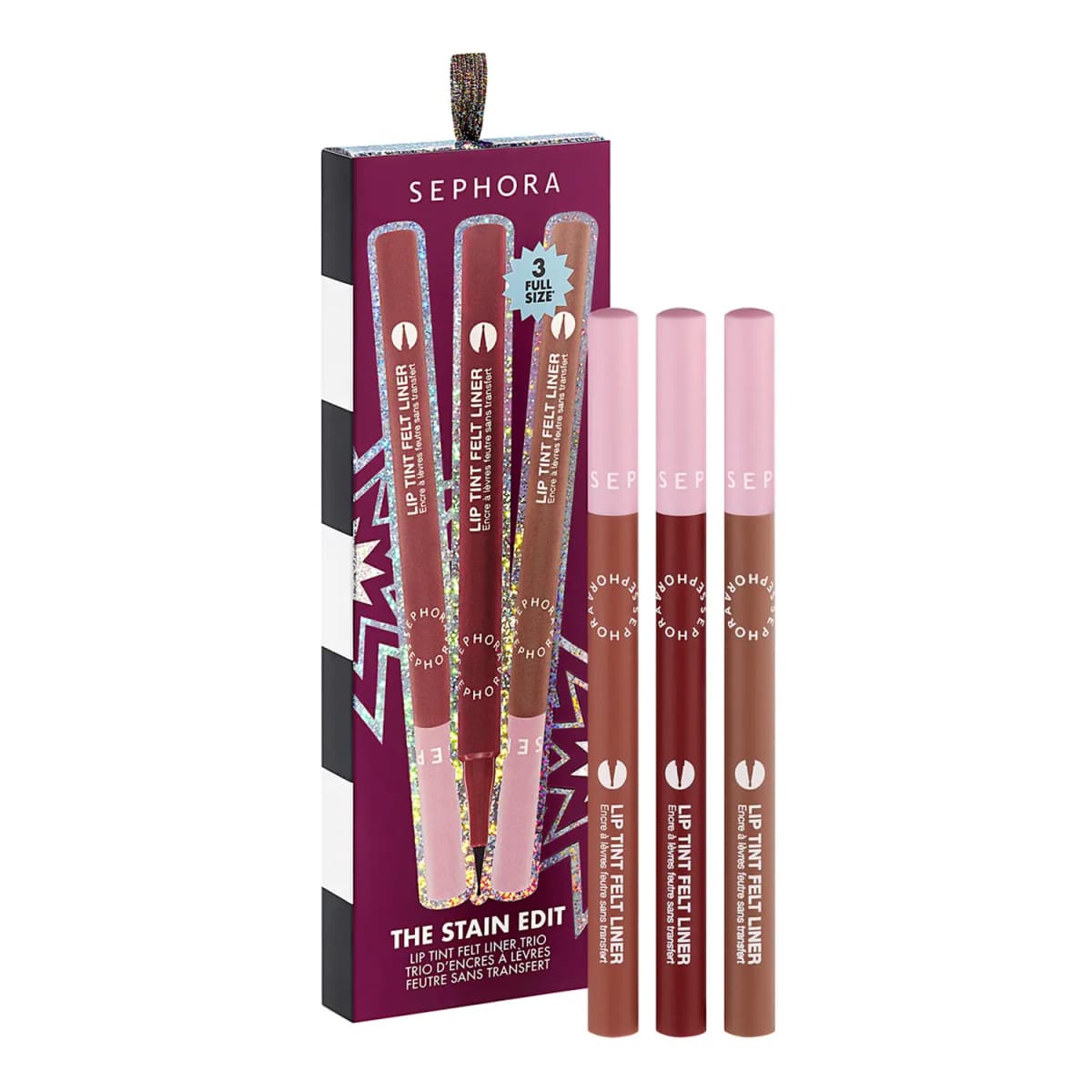 The Stain Edit trio of Lip Tint Felt Liners in brown, deep red and nude with pink caps beside a plum box