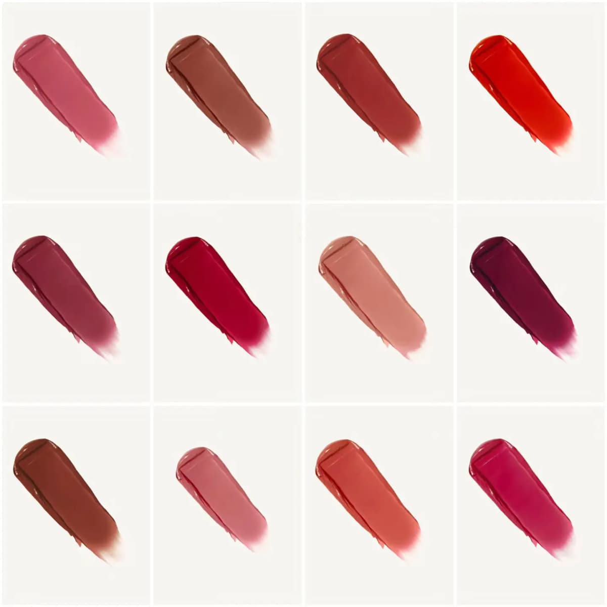 Grid of twelve unlabelled satin lipstick smears in pinks, browns, reds, berries and coral on cream backgrounds