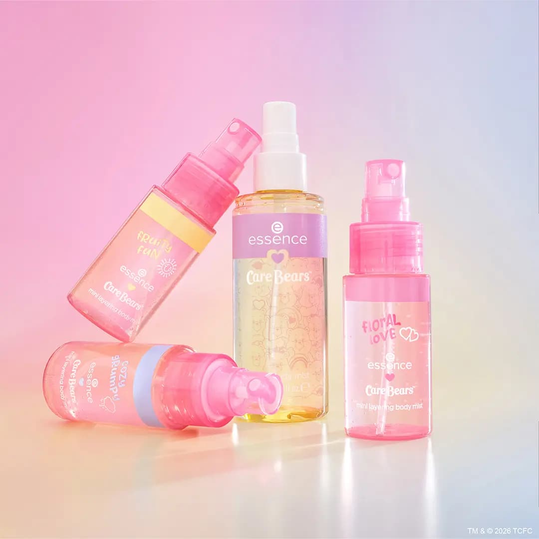 Three mini layering body mists in pink and yellow tinted bottles labeled Fruity Fun, Cozy Grumpy and Floral Love.