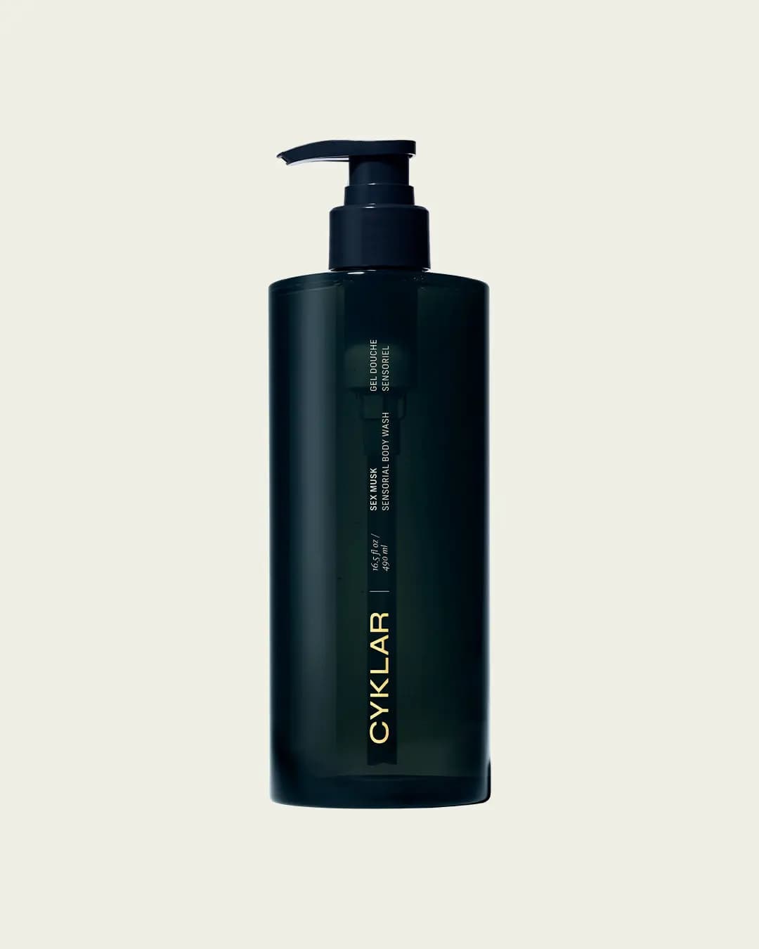 Dark green-black pump bottle of body wash with gold CYKLAR lettering on a plain cream background