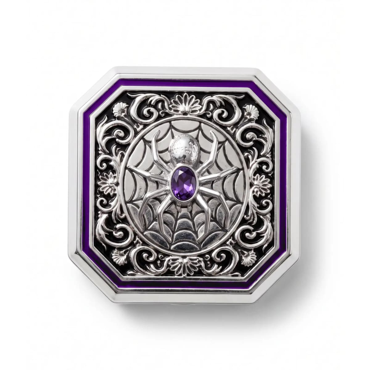Top-down view of octagonal silver compact lid with embossed spider, web, scrollwork and purple enamel border