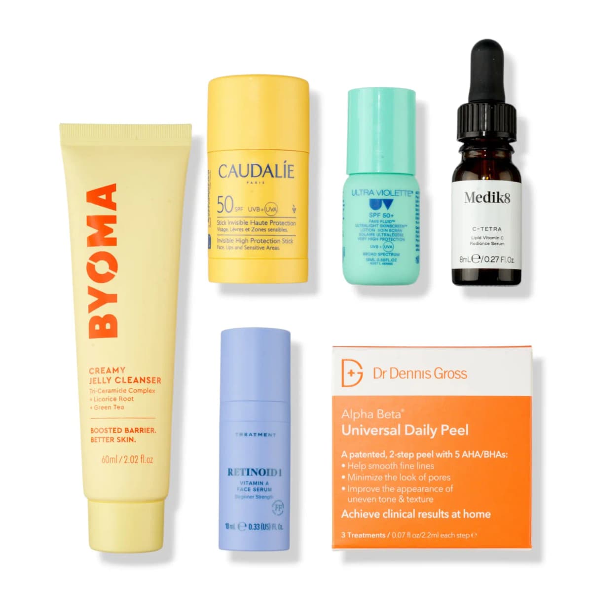 Flat lay of Byoma cleanser, yellow Caudalie SPF stick, mint Ultra Violette fluid, Medik8 dropper, Retinoid 1 and peel box