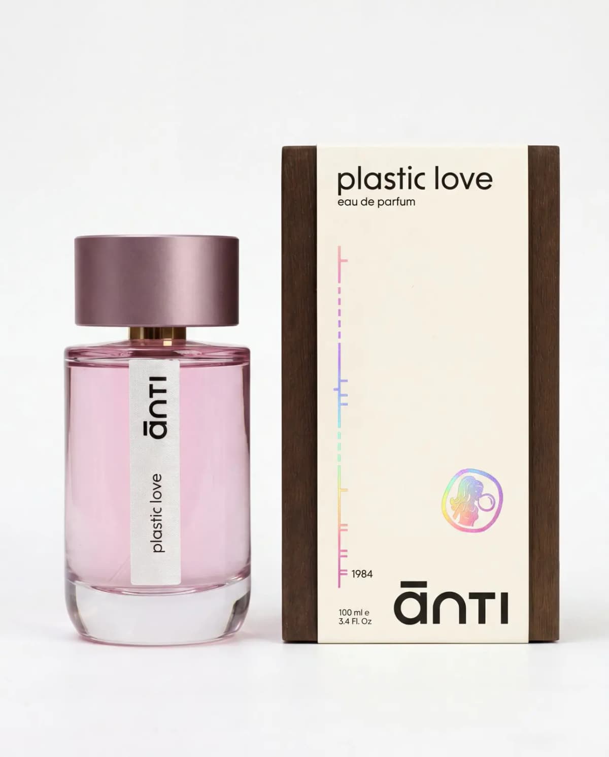 ānti Plastic Love Eau de Parfum bottle beside its cream box with dark wood-effect sides and a holographic logo