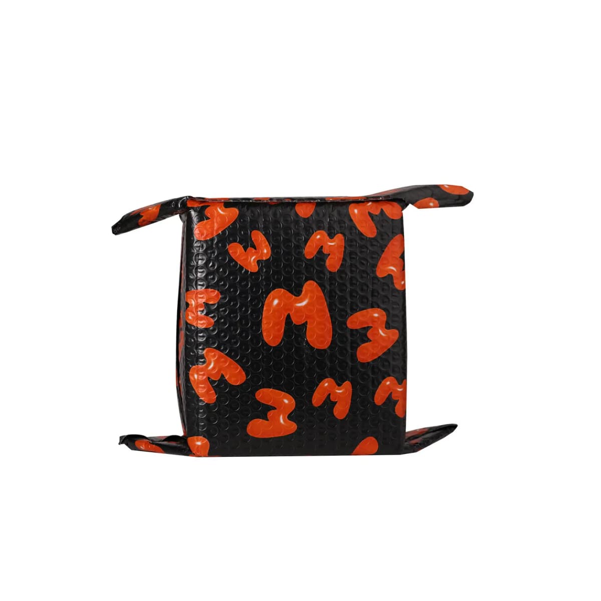 Black bubble mailer printed with glossy orange bubble M letters, folded around a boxed parcel