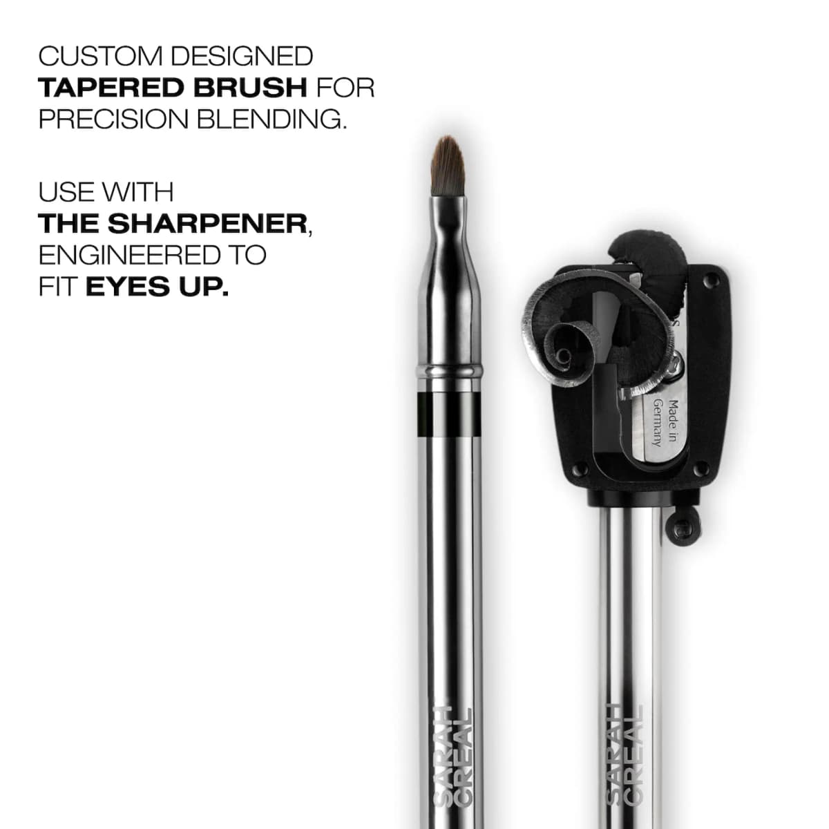 Silver pencil end with tapered brown blending brush next to a black Made in Germany sharpener with pencil shavings