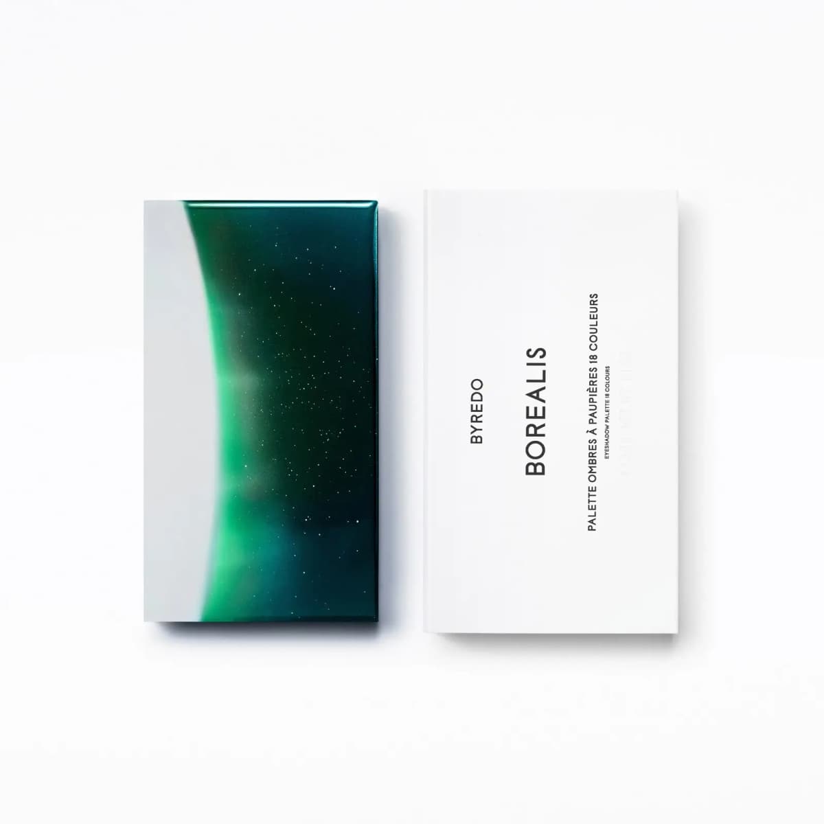 Closed compact with green aurora night-sky lid beside white box labelled Borealis 18 colours
