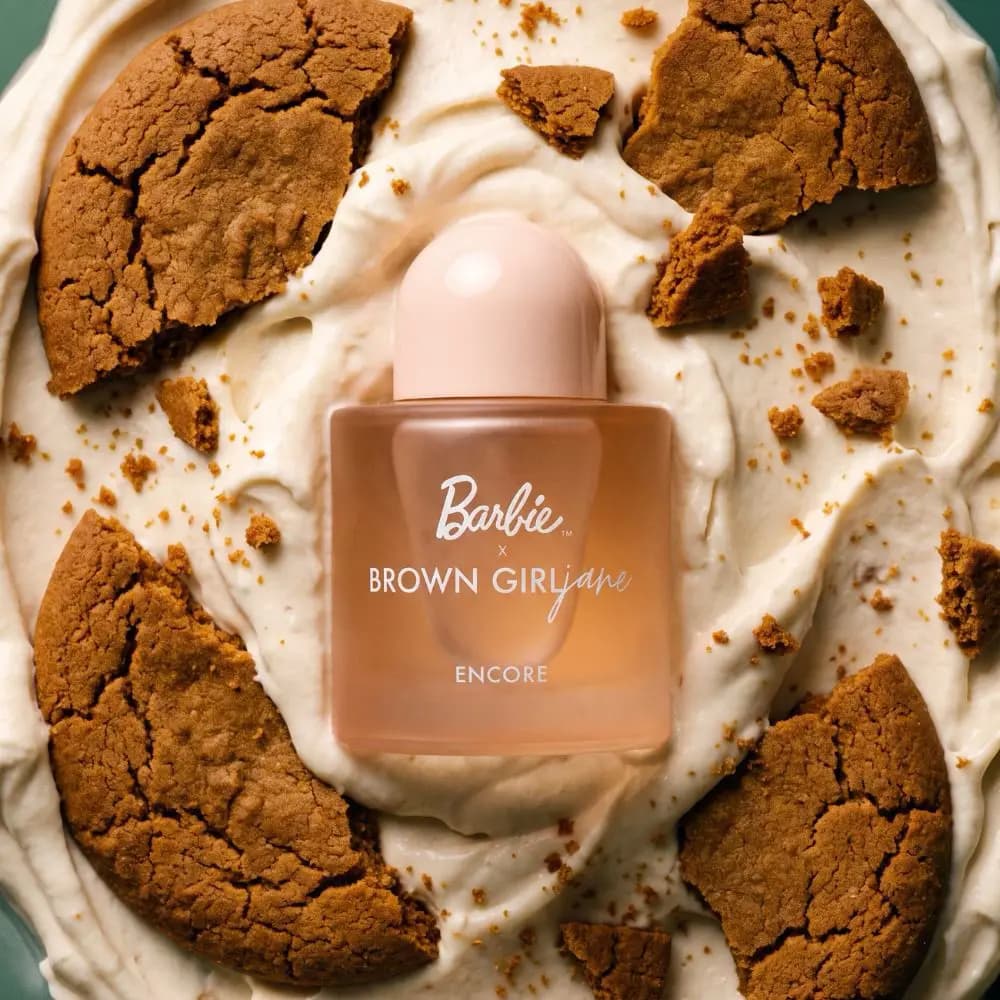 Encore Limited-Edition Barbie x Brown Girl Jane Eau de Parfum bottle in peach frosted glass on whipped cream