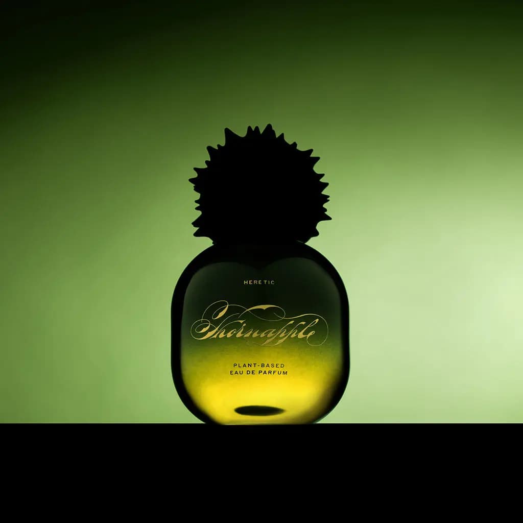 Thornapple bottle silhouetted against a glowing green backdrop, its spiked cap dark and gold script lit up.
