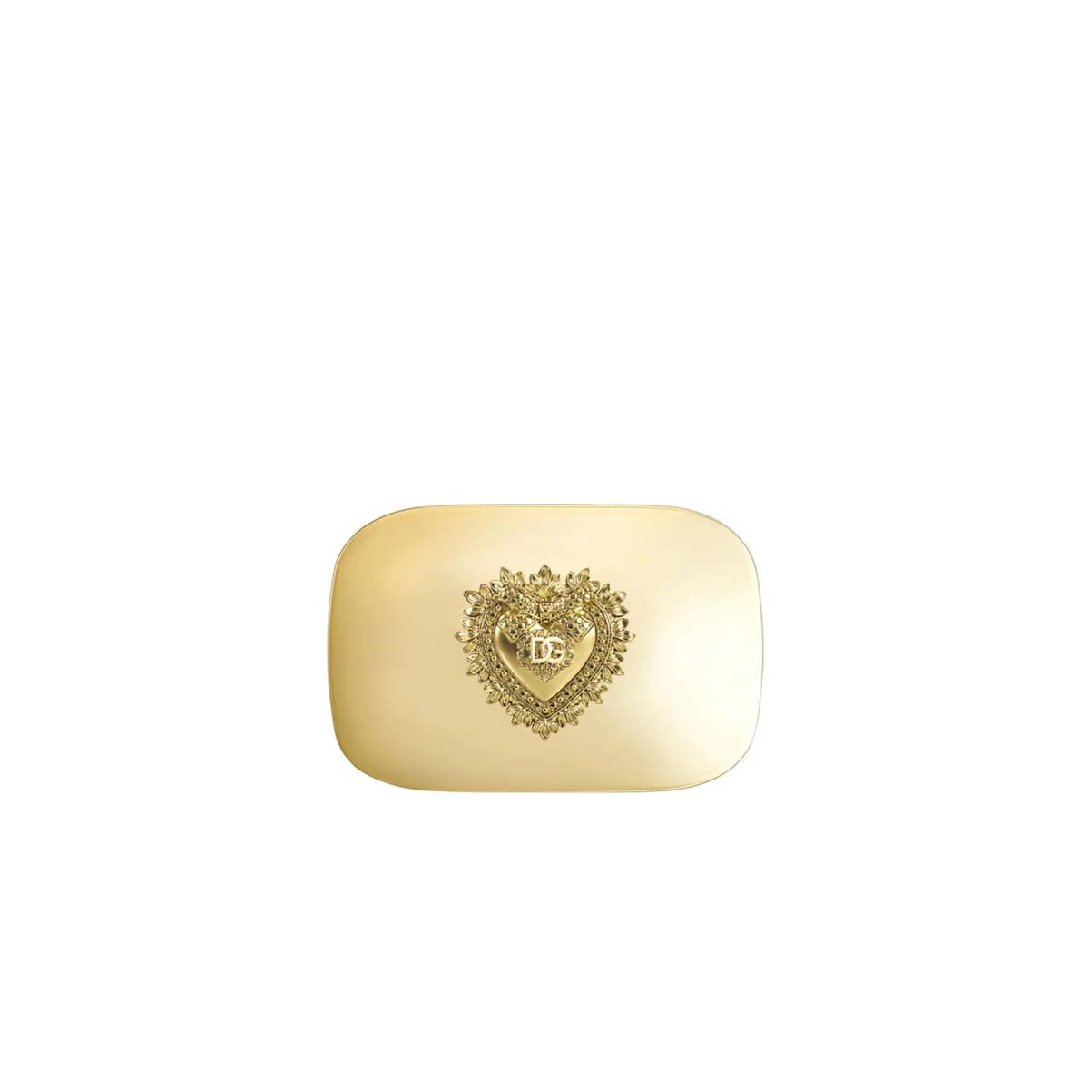 Closed gold compact lid with an ornate raised DG sacred-heart emblem on a white background