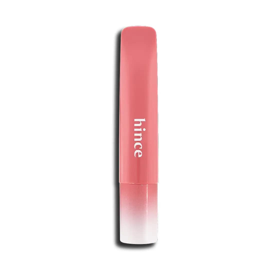 Coral pink hince lip balm tube with white logo and coral-to-white gradient cap