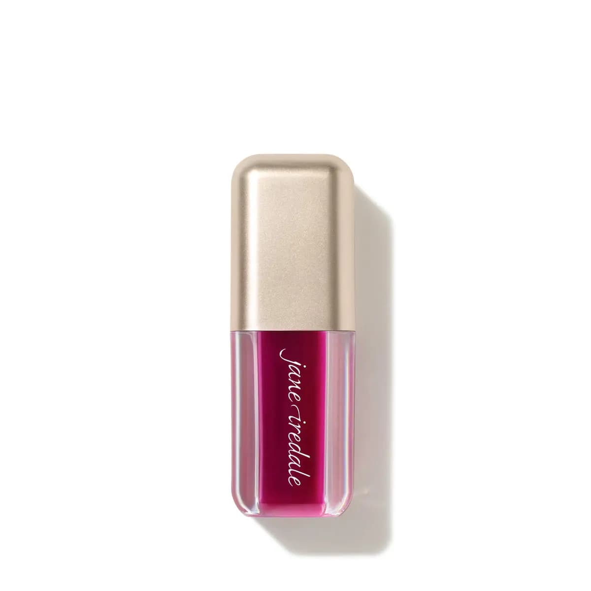 Jane iredale lip oil in a deep berry-magenta shade with a champagne-gold cap, standing on a white background.