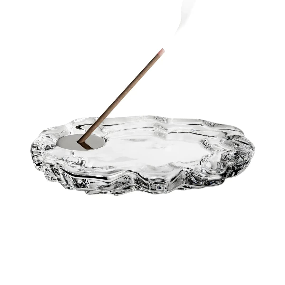 Flat rippled clear glass incense holder with a smoking incense stick in a metal insert