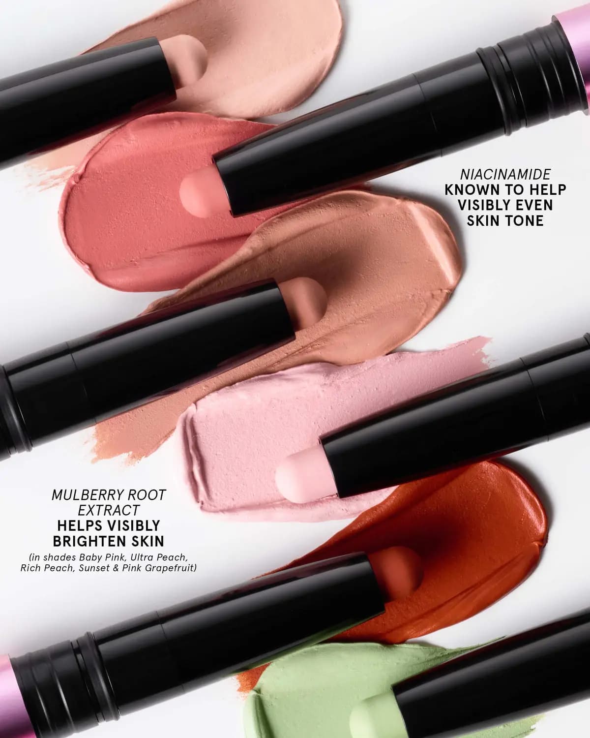 Creamy smears of peach, coral, pink, red-orange and green beside stain sticks, noting niacinamide and mulberry root extract