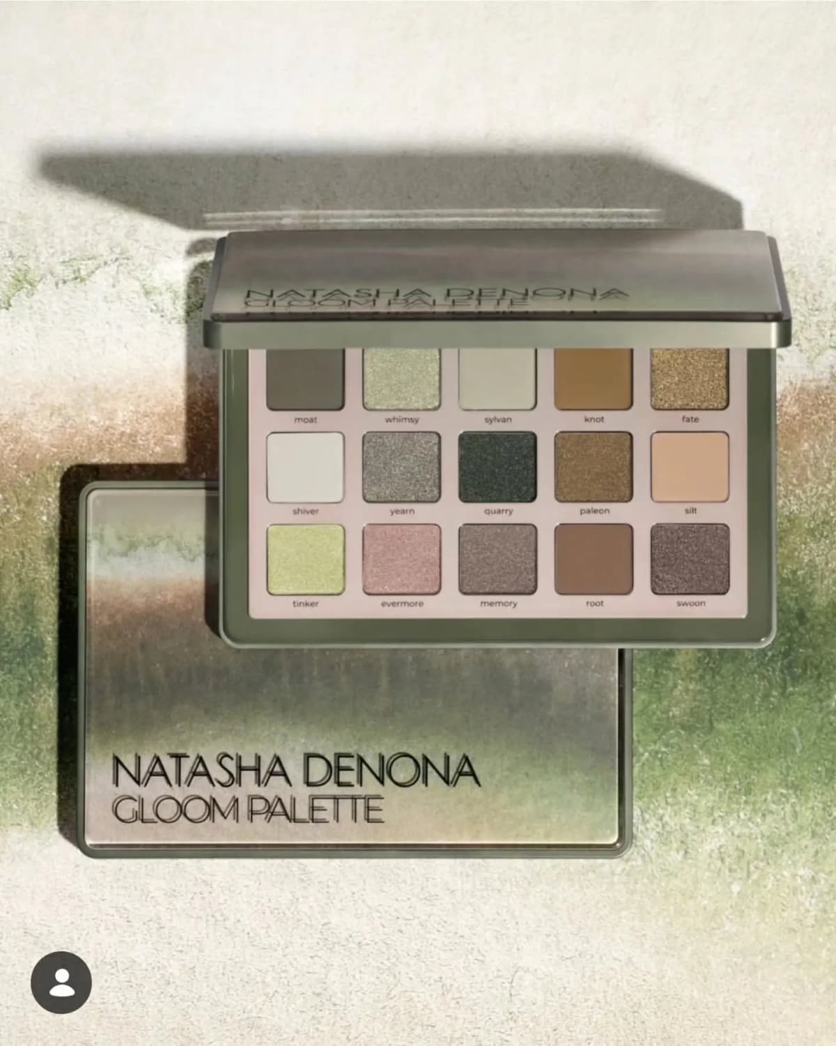 Natasha Denona Gloom Palette open on a mossy green background, showing 15 eyeshadows in greens, browns, taupes and gold.