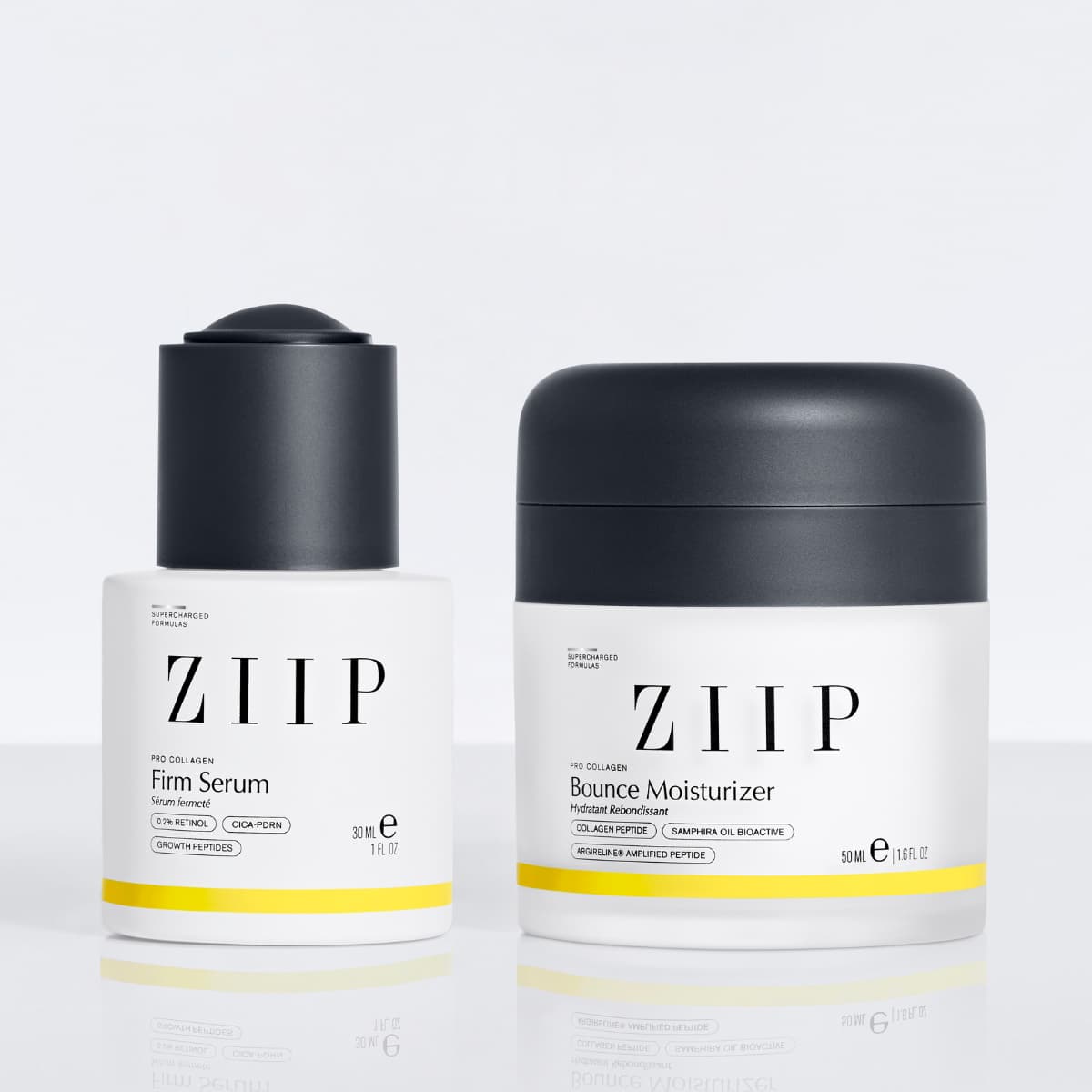 Firm Serum and Bounce Moisturizer duo with dark grey caps on a reflective white surface
