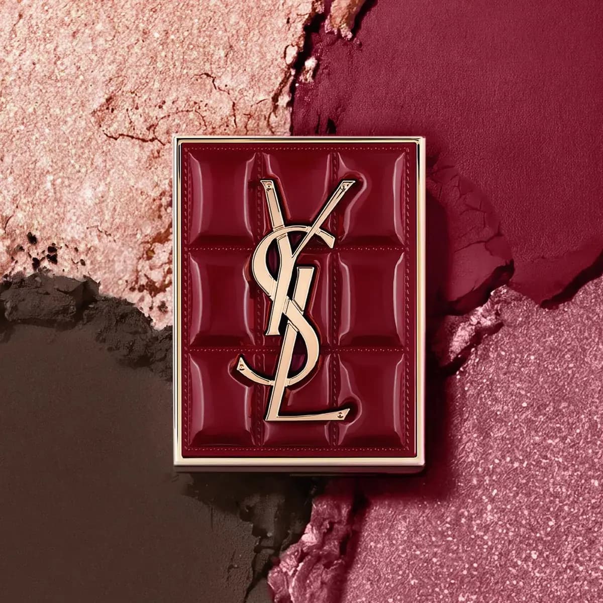 Quilted burgundy lacquer palette lid with gold YSL logo over pink, brown and berry powder smears