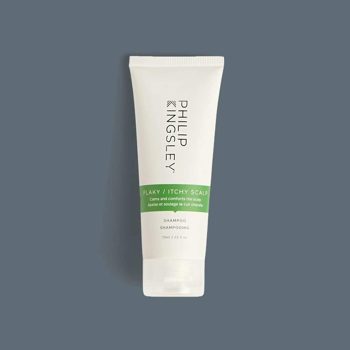 White Philip Kingsley Flaky/Itchy Scalp Shampoo 75ml tube with green band and clear cap on slate grey