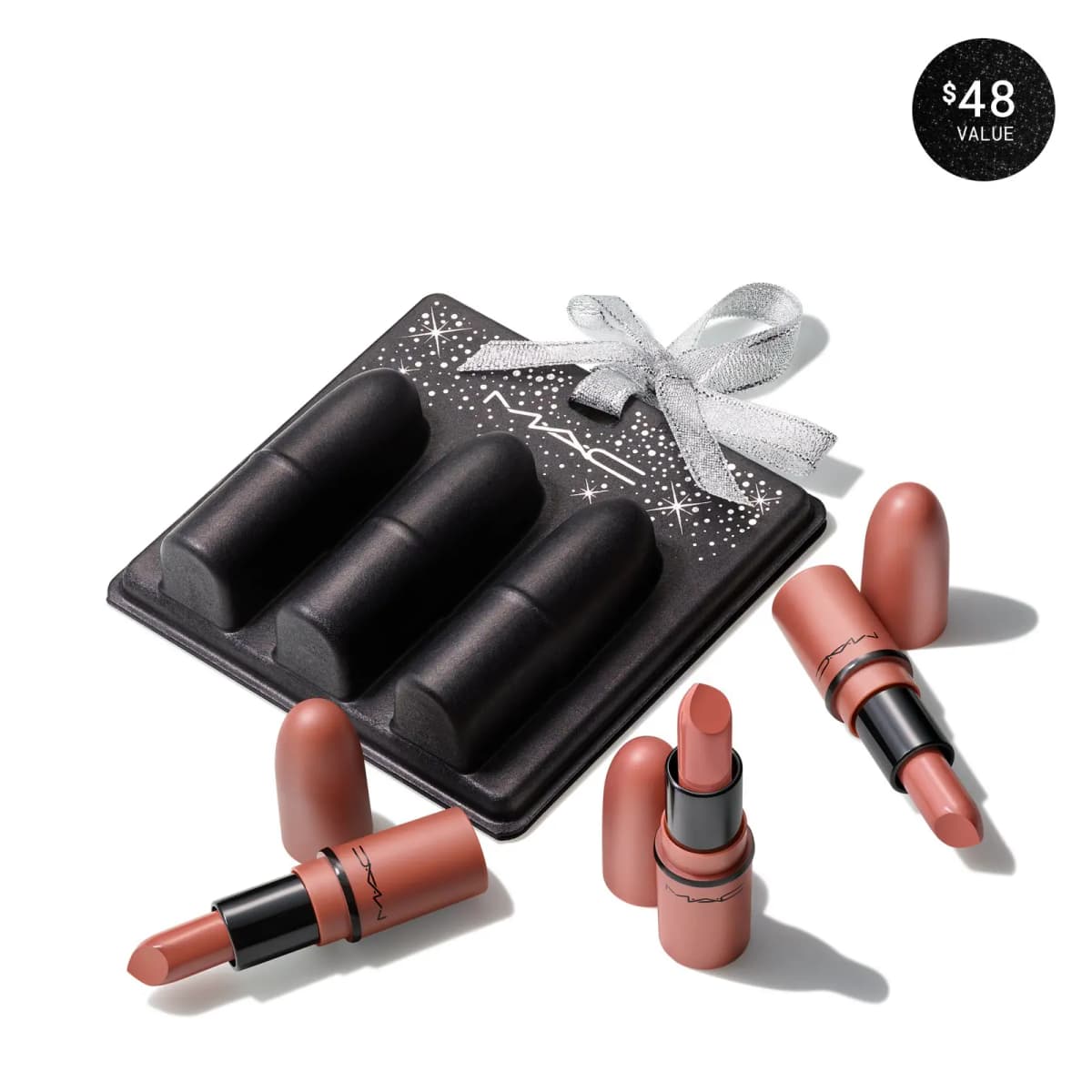 Three mini nude-pink M·A·C lipsticks beside a black tray ornament with a silver ribbon bow; $48 value badge.