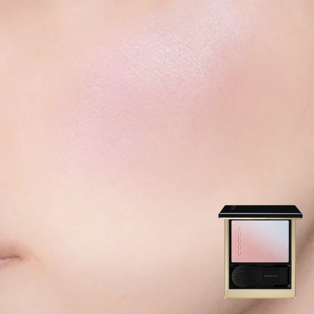 Soft cool-pink blush with a pearly sheen blended on a cheek, compact inset in the corner