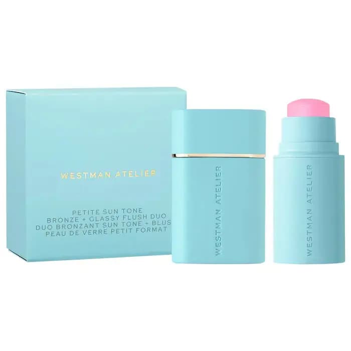 Pale aqua Westman Atelier Petite Sun Tone duo box beside matching bronzer stick and pink blush stick