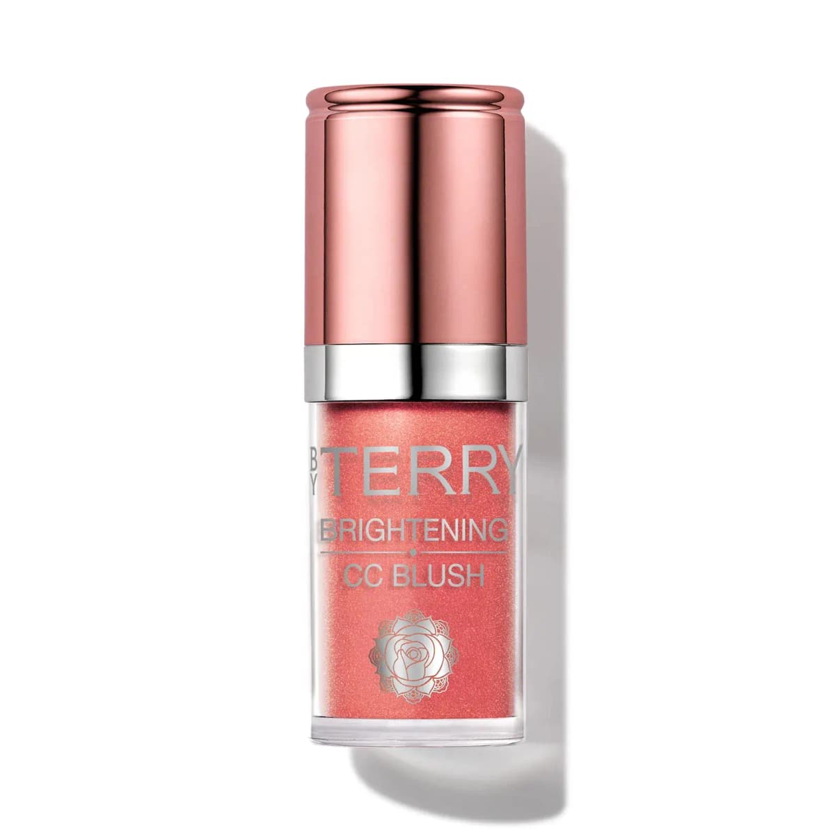 By Terry Brightening CC Blush in a bright coral-pink with glowy shimmer, rose-gold cap, against white.