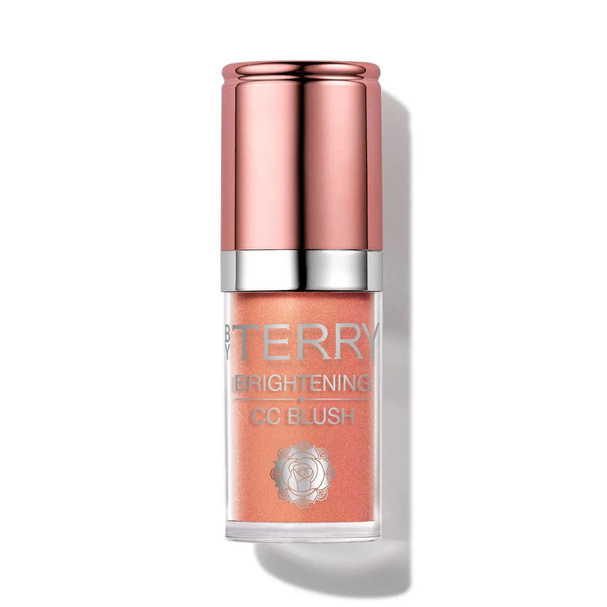 By Terry Brightening CC Blush in a shimmering peachy apricot shade with rose-gold cap and silver band, on white.