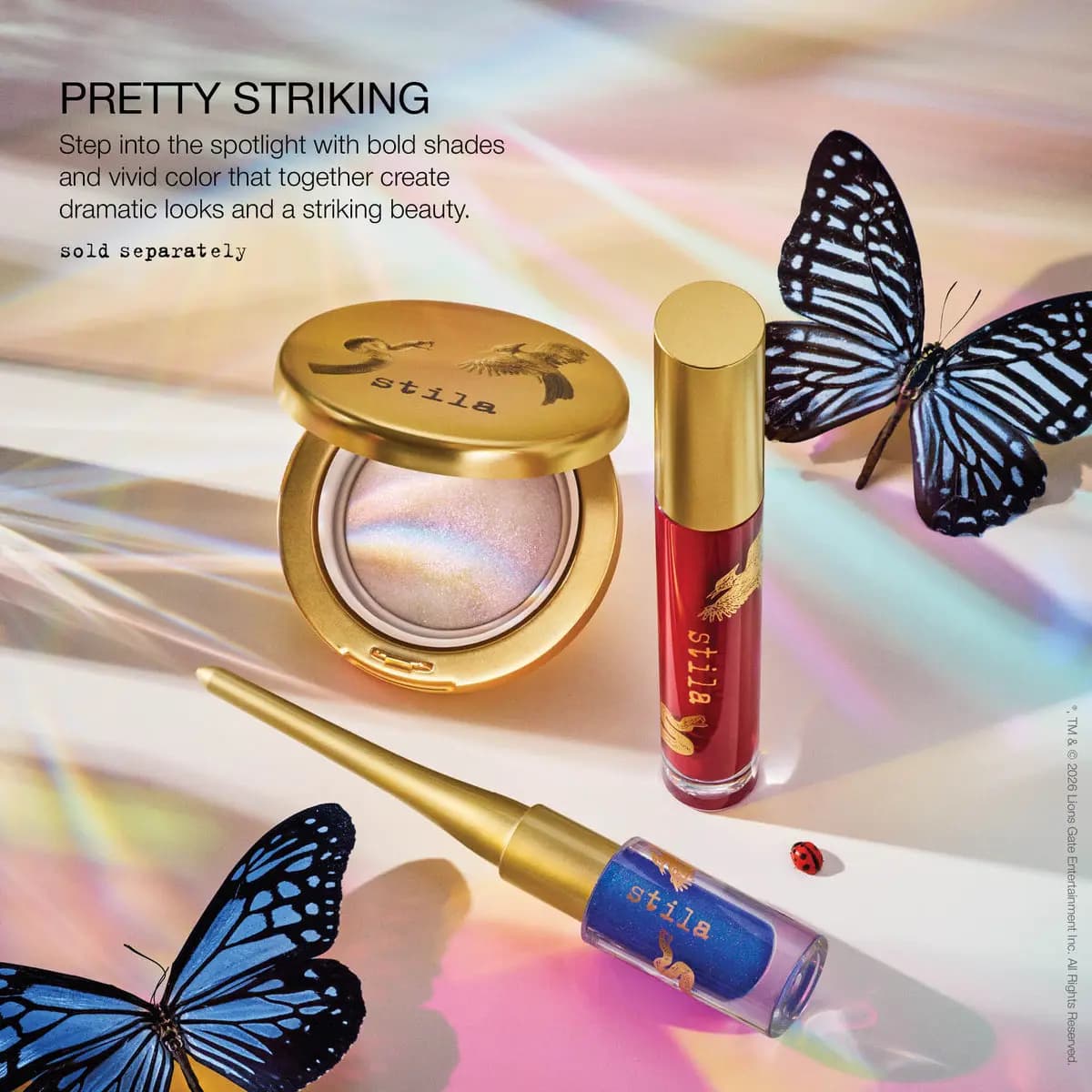 Pretty Striking look: iridescent glimmer compact, red liquid lip and blue shimmer liner among butterflies and rainbow light